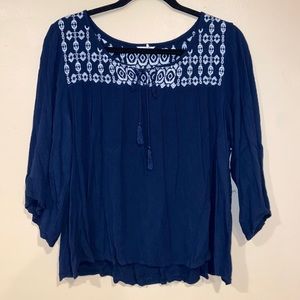 blue top with a white sewn design